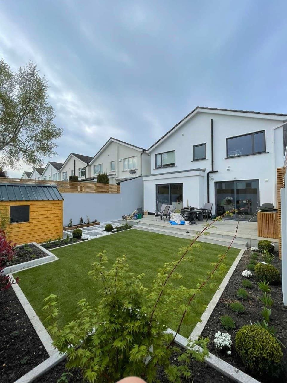 Finished rear garden with new lawn, granite edging, planting beds, raised patio and fencing